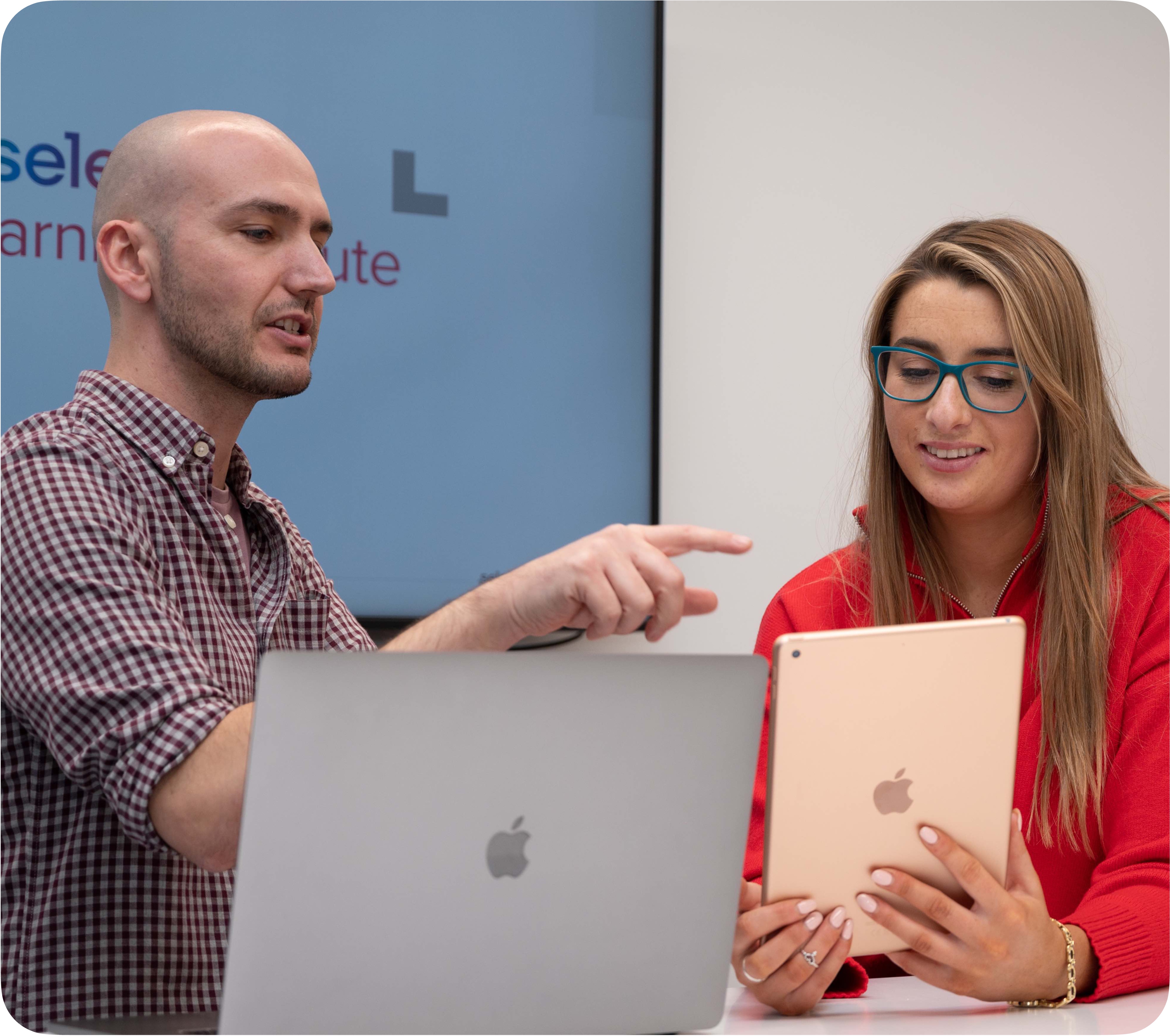 Apple Education Specialist explaining iPad and Mac use in a classroom setting